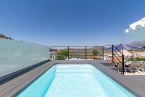 a swimming pool on the roof of a house at Luxury apartment in Cómpeta