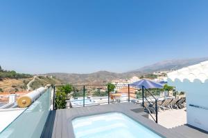 a swimming pool on the roof of a house at Luxury apartment in Cómpeta