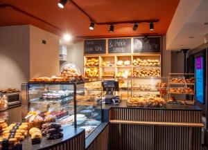 a bakery with a display case filled with lots of pastries at Stylish Aurora Studio with Mountain Views Lenzerheide in Lenzerheide