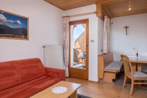 a living room with a couch and a table at Gamperhof Apartment Latemar in Collepietra