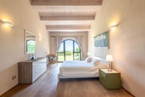 a bedroom with a bed and a large window at Villa Falco in Trequanda +37 photos