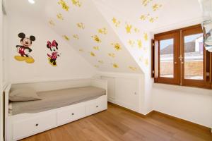 a bedroom with mickey mouse decals on the wall at Casa do Marquês in Vila Real de Santo António