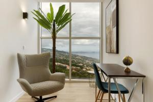 a room with a chair and a table and a window at Casa Belavista in Gaula