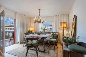 a dining room with a table and chairs at Haus Alpenveilchen - Appartement 3 in Schönau am Königssee +13 photos