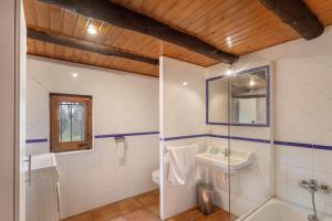 a bathroom with a tub and a sink and a toilet at Cal Cisteller in Olvan +18 photos