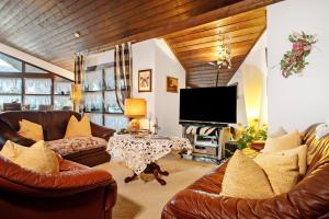 a living room with two couches and a tv at Ferienwohnung Schindele in Langenargen