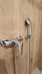 a shower head is attached to a wooden wall at Magda - Cala En Porter in Cala en Porter +21 photos