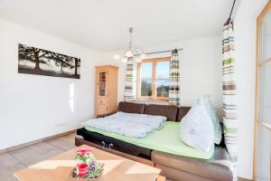 a living room with a couch and a bed at Ferienwohnung Bergblick in Bad Heilbrunn
