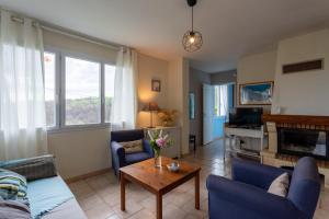a living room with a couch and a table at La maison de vacances Mathieu in Artigues