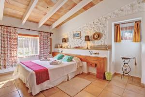 a bedroom with a bed and a desk at Ca les Estamenyes in Pollença