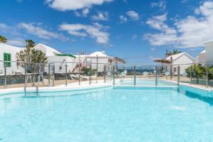 a large swimming pool in front of a resort at Bungalow Alma Ocean View in Puerto del Carmen