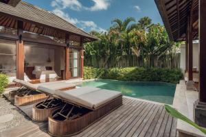 a bedroom and a pool in a villa at Asvara Villa Ubud by Ini Vie Hospitality in Ubud +40 photos