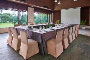 a long table in a room with chairs and a projection screen at MUTHI MAYA Forest Pool Villa Resort - SHA Plus Certified in Mu Si +57 photos