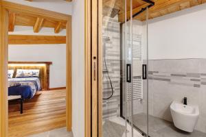 a bathroom with a glass shower and a bed at La Maison du Brenand in Rhêmes-Notre-Dame +77 photos