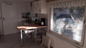 a small kitchen with a table and a window at Ferienwohnungen Hiddenseeblick 3 in Dranske