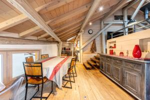a kitchen with a long table and chairs at Le Galetas in Brides-les-Bains +15 photos