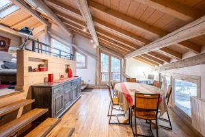 a kitchen and dining room with a table and chairs at Le Galetas in Brides-les-Bains