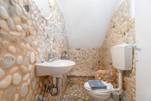 a bathroom with a toilet and a sink at Green Retreats 4 Paros in Isterni