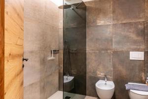 a bathroom with a shower with a toilet and a sink at Blosegghof Bergchalets Talblick in Racines +35 photos