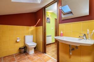 a bathroom with a toilet and a sink at Esteiro in Céltigos +20 photos