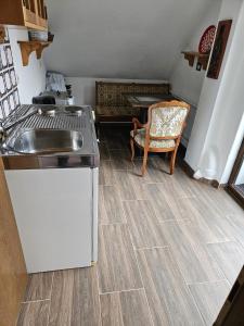 a kitchen with a sink and a table at Am Wehrastrand Einzelappartment in Todtmoos