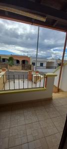 a balcony with tables and chairs on a building at Villetta Nicola in Salve +4 photos