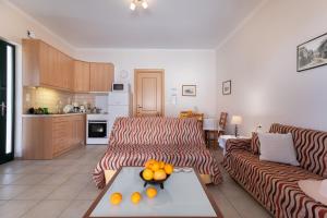 a living room with a couch and a table at Villa Votistis A1 in Lefkada +19 photos