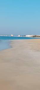 a view of the beach with the ocean in the background at Villetta Nicola in Salve