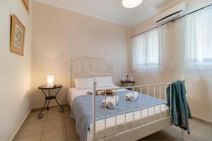 a small bedroom with a bed and a window at Villa Votistis A1 in Lefkada