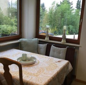 a table and chairs with a table and a window at Ferienwohnung Beletage mit Terrasse in Neuwied