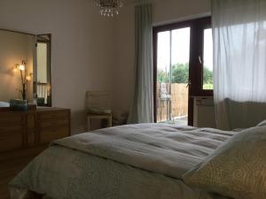 a bedroom with a bed and a window and a mirror at Ferienwohnung Beletage mit Terrasse in Neuwied