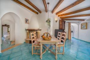 a dining room with a table and chairs and a fireplace at Villa Lumaca in Porto Rotondo