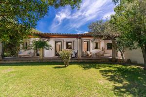 an exterior view of a house with a yard at Villa Lumaca in Porto Rotondo
