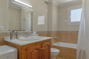 a bathroom with a sink and a toilet and a mirror at Céntrico apartamento en Tarifa in Tarifa +16 photos