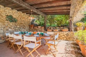 a wooden table and chairs on a patio at Villa Les Ombrelles in Portoferraio