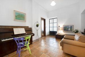 a living room with a piano and a couch at Wakesurfhouse in Sulzano