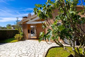 a house with a stone driveway in front of it at Maisonnette Botticelli - Ares in Arès