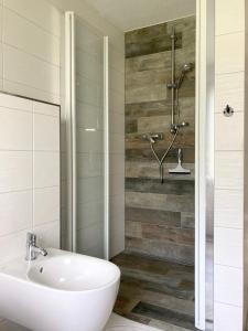 a bathroom with a shower and a white sink at Bungalow 314 in Joachimsthal +20 photos