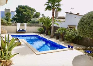 a swimming pool in the backyard of a house at Ocean Blues in Cala Santanyi