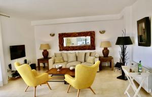 a living room with a couch and chairs and a table at Ocean Blues in Cala Santanyi