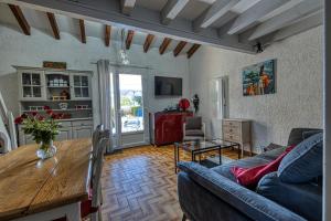 a living room with a blue couch and a table at Maisonnette Botticelli - Ares in Arès