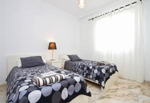 a bedroom with two beds and a window at Villa Benedicte in Puerto del Carmen +6 photos