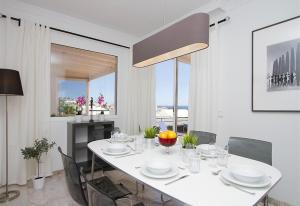 a white dining room with a white table and chairs at Villa Benedicte in Puerto del Carmen