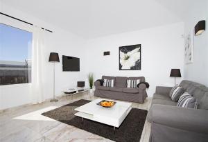 a living room with a couch and a table at Villa Benedicte in Puerto del Carmen