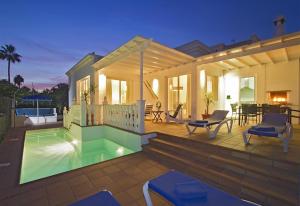 a villa with a swimming pool and a house at Villa Benedicte in Puerto del Carmen