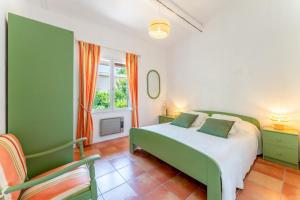 a bedroom with a green bed and a chair at Lou Cigaloun in Bédoin +18 photos