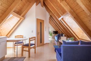 an attic room with a table and chairs at Haus Sonnenschein in Eriskirch