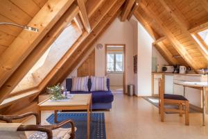 a living room with a blue couch and a table at Haus Sonnenschein in Eriskirch