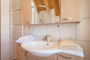 a bathroom with a sink and a mirror at Haus Sonnenschein in Eriskirch +11 photos