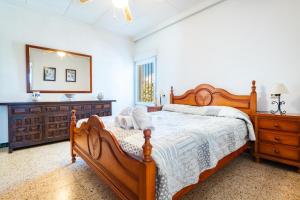 a bedroom with a large wooden bed and a mirror at Sorpresa in Vinarós +24 photos